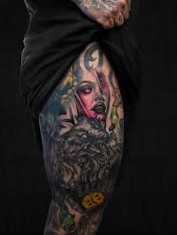 Colorful tattoo sleeve featuring a woman's face and a lion on a leg.