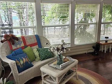 Enclosed sunroom featuring many large glass windows.