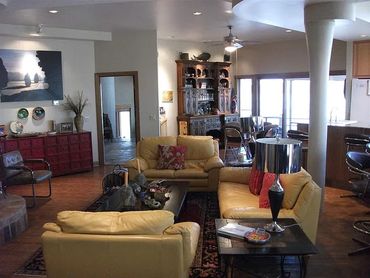 Spacious living room with yellow leather sofas.