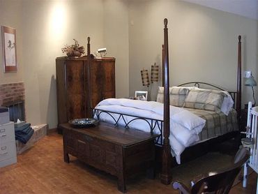 Elegant bedroom featuring a four-poster wooden bed.