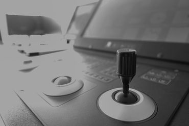 Close-up of a joystick controller on a device panel.