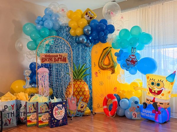 Colorful SpongeBob-themed birthday party setup with balloons and decorations.