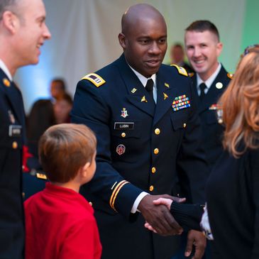 An Army officer greeting the families of those serving in medical roles within the armed forces.