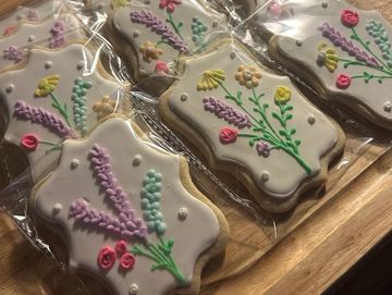 Decorative floral cookies individually wrapped in plastic.