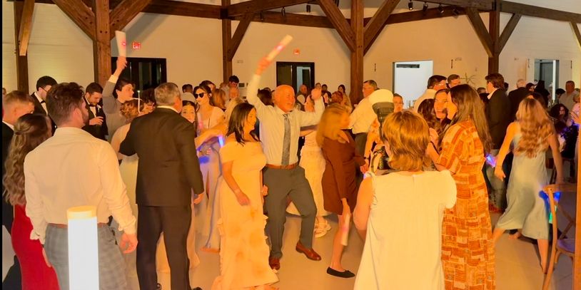 Packed wedding dance floor in Baton Rouge reception showing guest energy