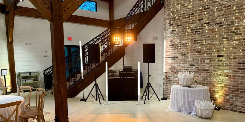 Wedding uplighting and clean DJ setup at Baton Rouge reception venue