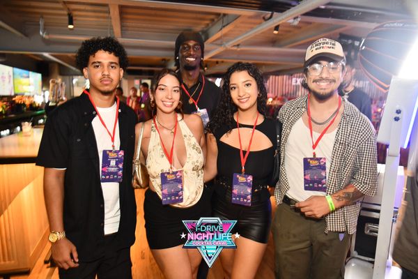 Group of five friends posing at a nightlife cocktail crawl event.