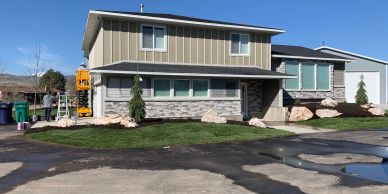 Modern two-story suburban house with green lawn.