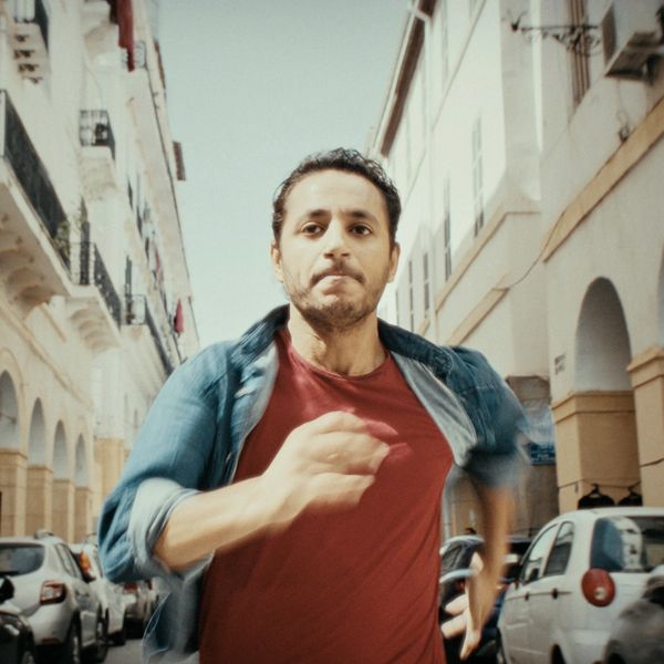 Man running intensely on a city street.