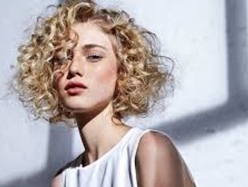 women with curly hair done by a master specialist stylist