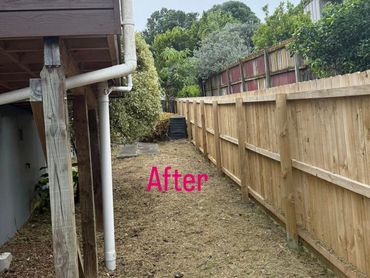 Cleaned and maintained backyard area with wooden fencing.