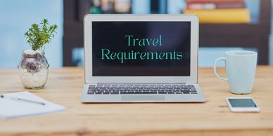 Desk with laptop and coffee for Travel-Mingo Sherpa travel info.