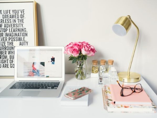 Professional desk with laptop and glasses prepared for a travel agency’s client consultation about tr