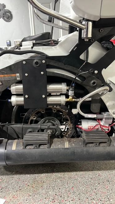 Close-up of a motorcycle's mechanical components and custom modifications.