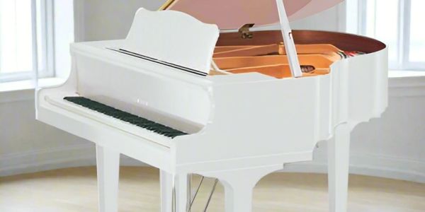 Elegant white grand piano in a bright room.