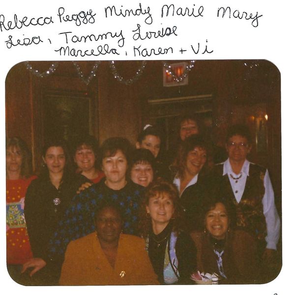 Group photo of women smiling indoors with handwritten names above.