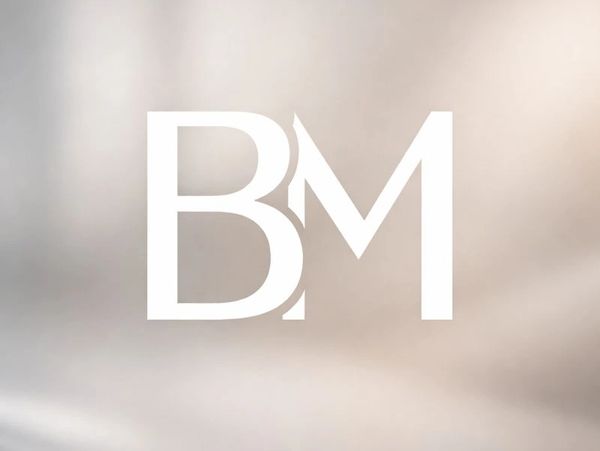 Stylish white BM logo on a soft beige background.