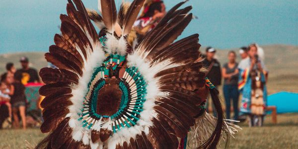 An Indigenous Dancer in Full Regalia.