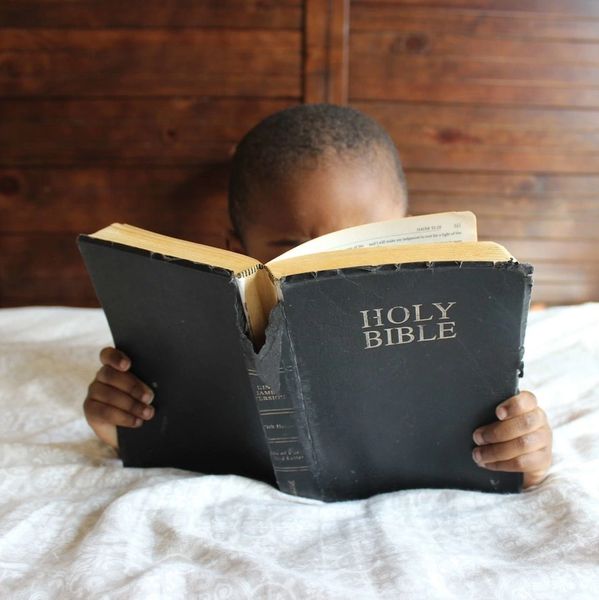 child reading bible; baby; doula; spiritual; pray; worship; 