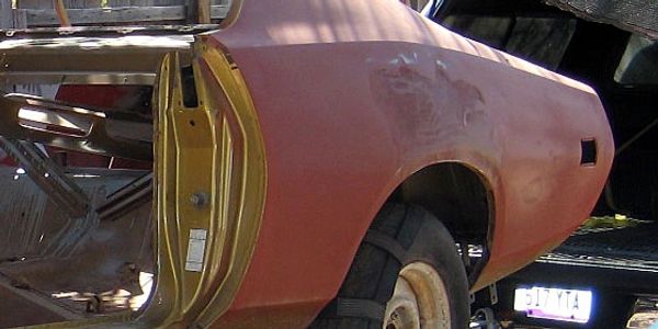 Rusty car body without tires and doors.