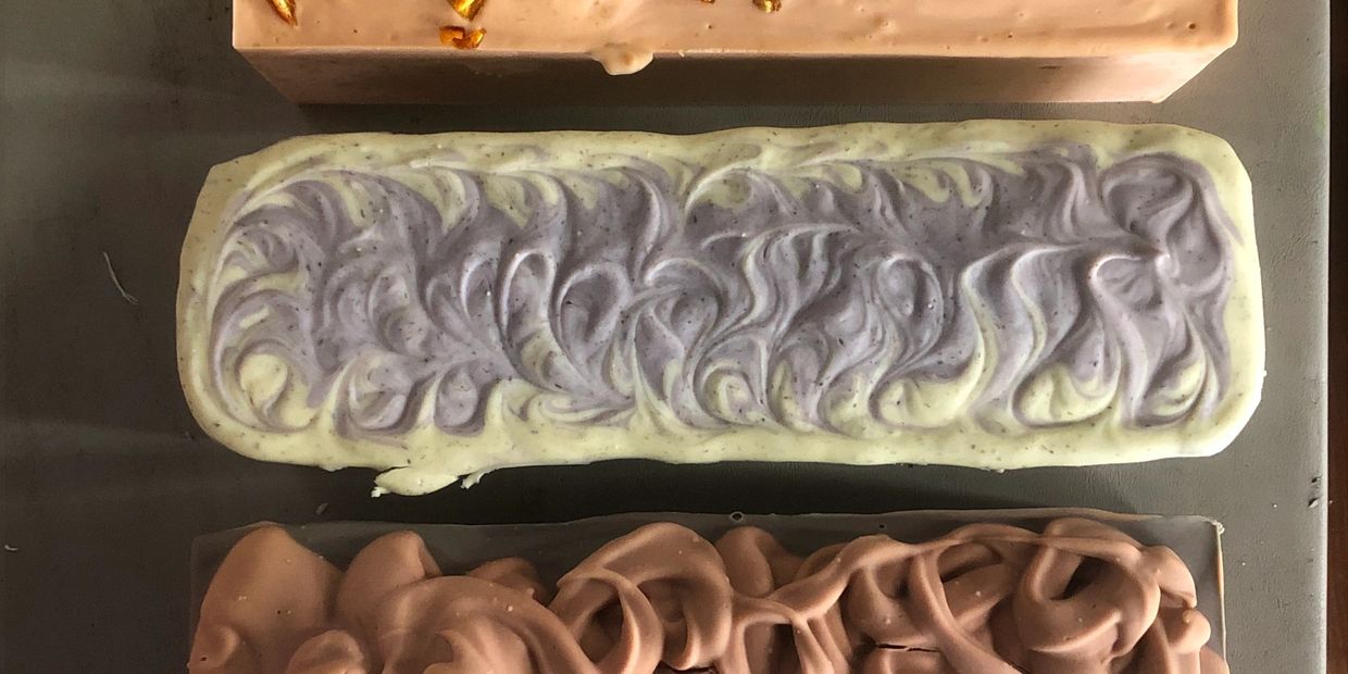 Three colorful, swirled chocolate bars in different flavors.