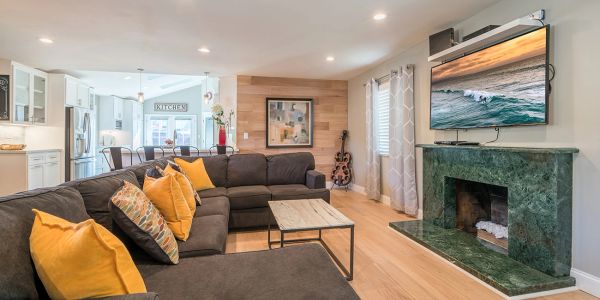 Spacious living room with large sectional sofa and mounted TV.