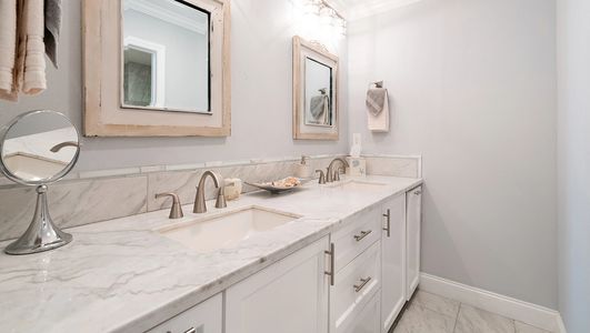 Modern bathroom with double sink and marble countertop.