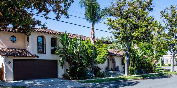 Spanish-style house with lush greenery.