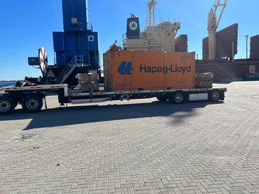 Shipping container secured on a step deck trailer at the Port of Panama City, FL