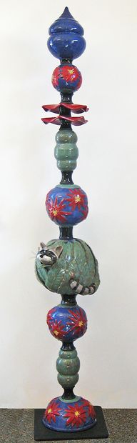 Purple and red floral beads with a raccoon peeking out through a leaf covered bead