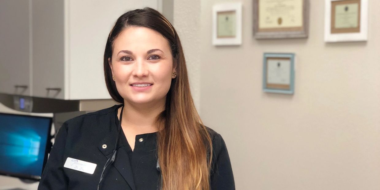 Smiling healthcare professional in an office setting.
