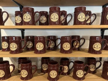 Mug club mugs on a shelf behind the bar