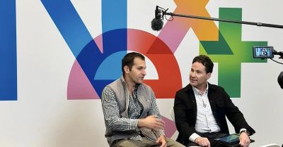 Two men having a recorded conversation with a colorful background.