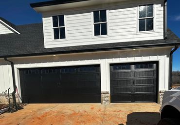 Stamped carriage garage doors with windows and decorative hardware installed in Dawsonville, GA by B