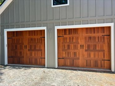Custom wood garage doors with decorative hardware installed in Forsyth County, GA by BB Garage Doors