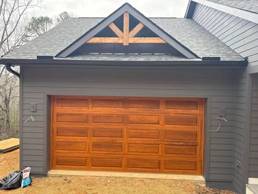 Long panel cedar garage door installed by BB Garage Doors in Dahlonega Ga