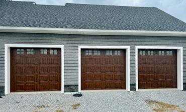 Three wood-look garage doors with decorative windows installed in Gainesville, GA by BB Garage Doors