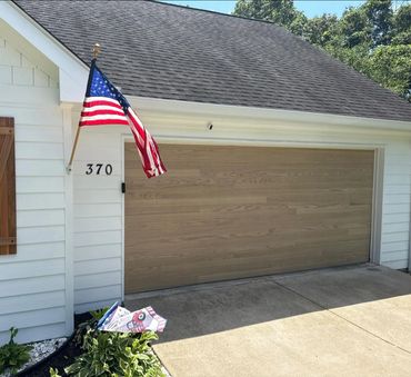 Plank-style wood-look garage door installed in Cumming, GA by BB Garage Doors.