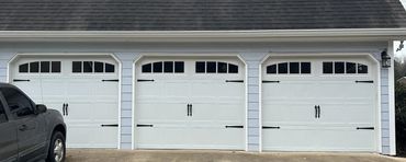 White carriage-style garage doors with arched windows . installed in Cumming, GA by BB Garage Doors.