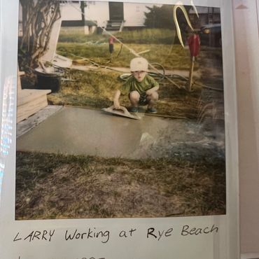 Young boy named Larry working with cement at Rye Beach in 1995.