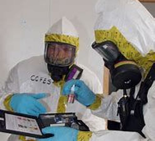 team in fully encapsulated suits