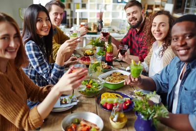A group of people eating 100% plant-based food and drinks.