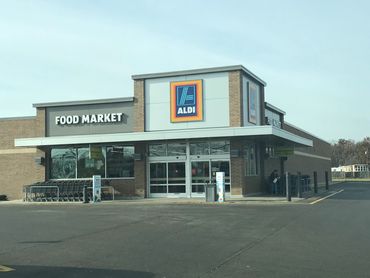 Exterior view of an ALDI food market with shopping carts outside.