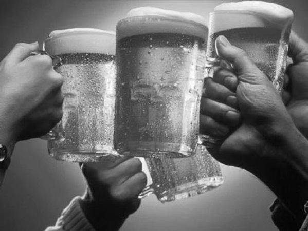People toasting with beer mugs.