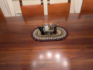 Wooden dining table with nature-themed salt and pepper shakers.