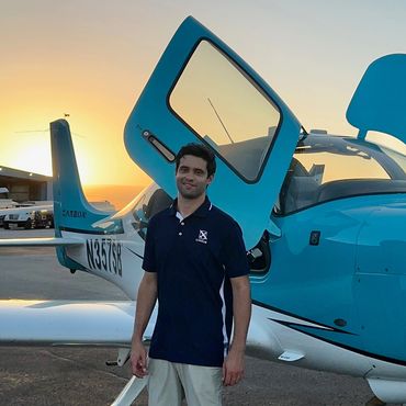 a man in black t shirt near a plane