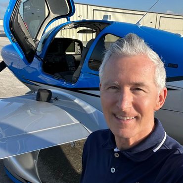 a pilot clicking a selfie with a plane
