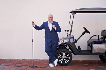 Stand-up comedian Danny Johnson next to a golf cart