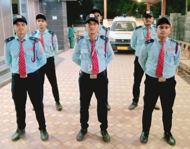 Six security guards standing in formation at night.