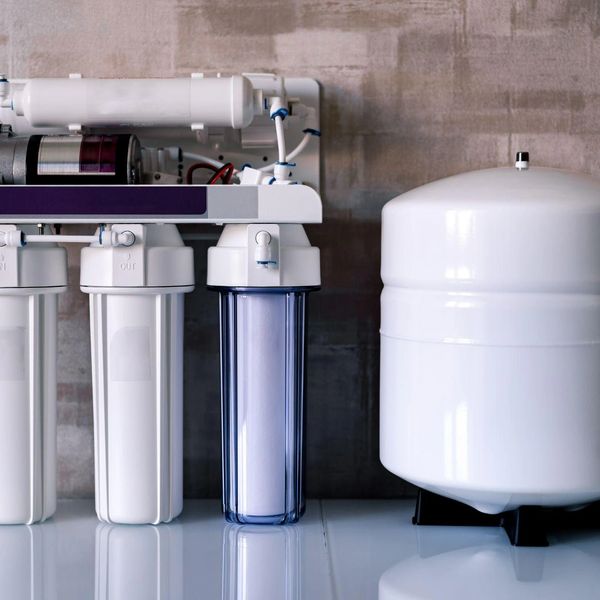 A modern reverse osmosis water filtration system with a white storage tank. Water filtration systems